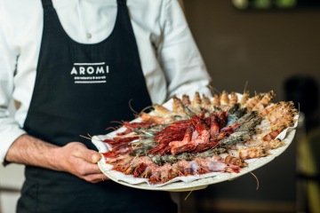 Grilled lamb chops in mint - pistachio crust with baby broccoli and sauce with capers